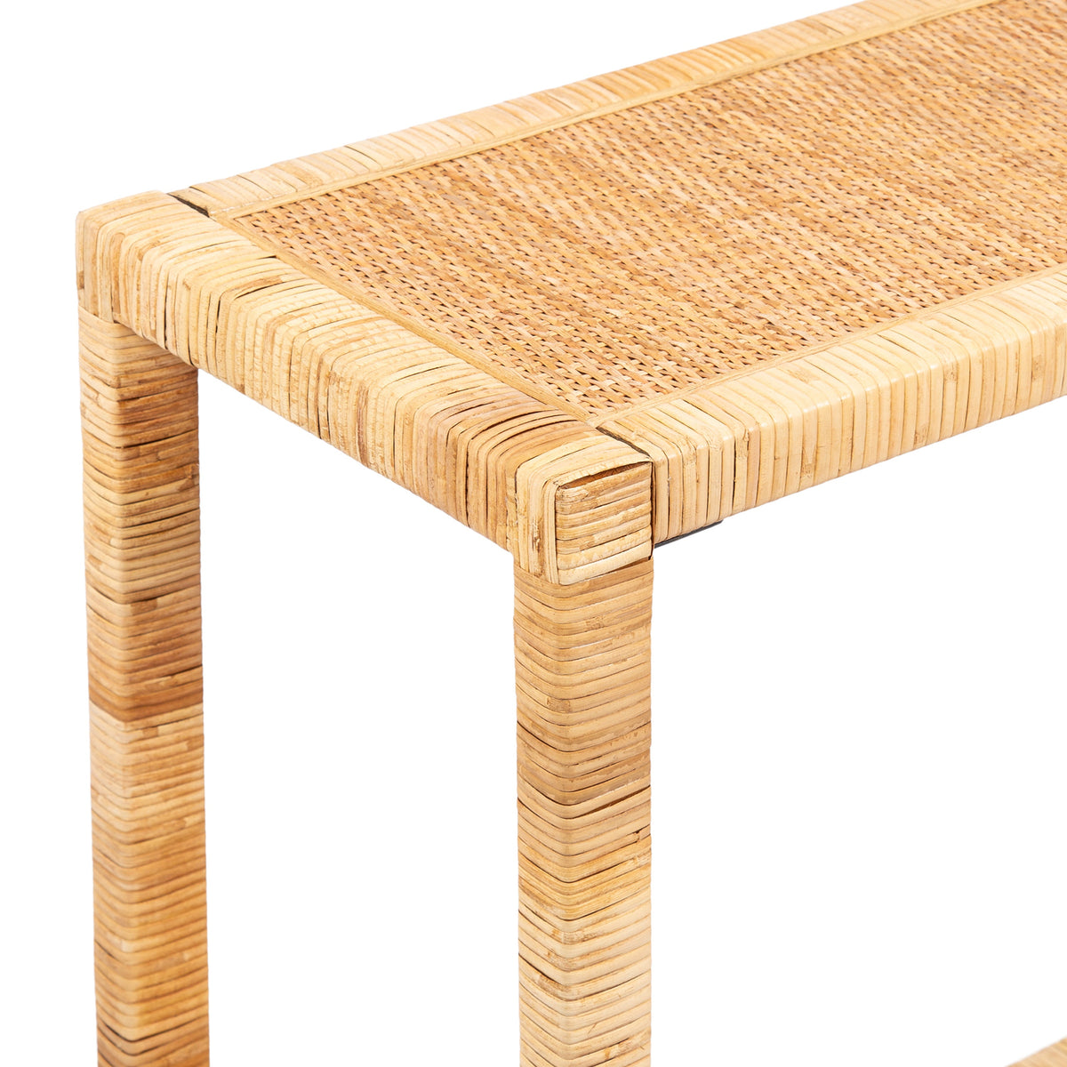 Corner close-up of a light tan rattan console table highlighting woven rectangular top and wrapped rattan legs with natural texture and subtle color variation.