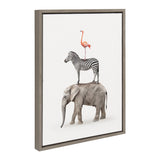 Framed canvas art showing a pink flamingo standing on a black-and-white zebra, which stands on a gray elephant, all set against a white background.