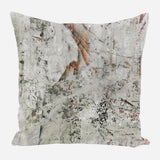 Square pillow with an abstract textured pattern in muted gray, white, and rusty orange tones resembling weathered bark or stone surfaces.