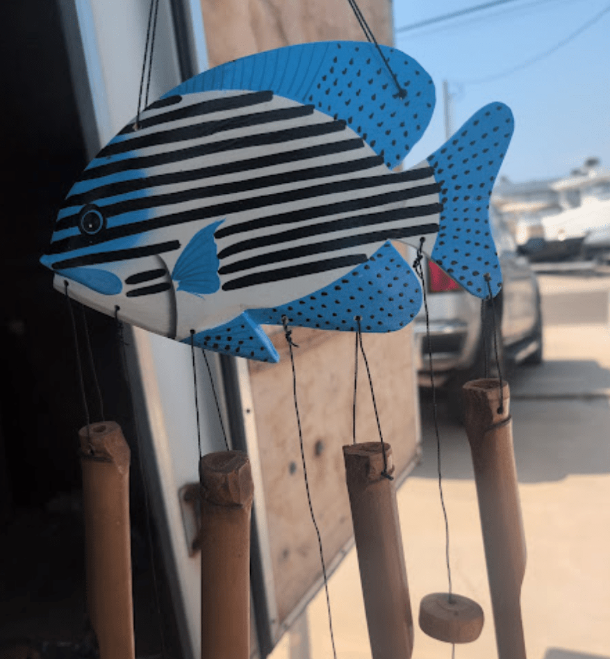 Wooden Fish Wind Chime in multiple colors hanging outdoors