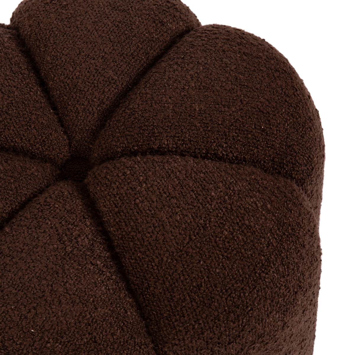 Close-up of a round brown tufted ottoman with a textured fabric surface segmented into petal-like sections converging at the center.