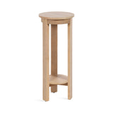 Tall round wooden side table with three straight legs and a lower circular shelf, finished in natural light wood tone.