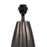 Matte black metal lamp base with vertical scalloped ridges tapering upwards, topped by the socket for a table lamp bulb.