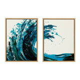 Two framed canvas art pieces featuring abstract blue and black wave patterns with splashes on a white background, evoking ocean movement and energy.