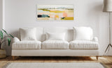 Abstract landscape painting with soft green, yellow, pink, and black brushstrokes in a white frame above a white three-seat sofa in a minimalist living room.