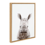 Framed canvas print featuring a close-up front view of a baby rhino with textured gray skin and large ears against a white background.
