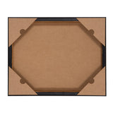 Back view of a rectangular framed canvas with four brown corner protectors and a cardboard backing secured by a black wooden frame.