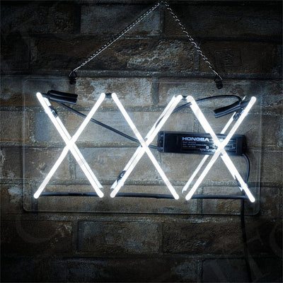 XXX Neon Signs illuminated against a dark background, showcasing bright neon glow with acrylic backing and hanging chain