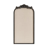 Tall beige fabric pinboard with an arched black frame topped by ornate dark metal scrollwork decoration.
