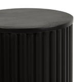 Close-up of a circular black drink table with a smooth top and vertically grooved cylindrical base against a white background.