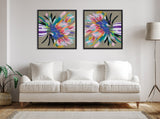 Two framed colorful floral abstract canvases with pinks, greens, and blues hang side by side above a white three-seat sofa in a minimalist living room.