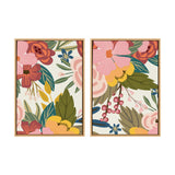 Two framed canvas prints featuring colorful floral patterns with large pink, red, and yellow flowers and green leaves on a light background in a side-by-side arrangement.