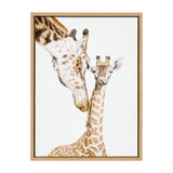Close-up portrait of a mother giraffe nuzzling her baby giraffe against a plain white background, framed in light wood.