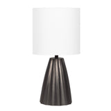 Table lamp with a white cylindrical shade and a dark gray metallic scalloped base with vertical grooves, shown against a white background.