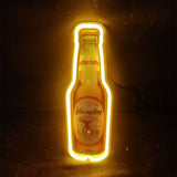 Yellow neon light outlining a Yuengling Lager beer bottle against a dark background, highlighting the bottle's shape and label details.