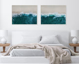 Two framed canvas prints above a bed depict aerial views of sandy beach waves with teal and white foam crashing along the shore, arranged side by side.