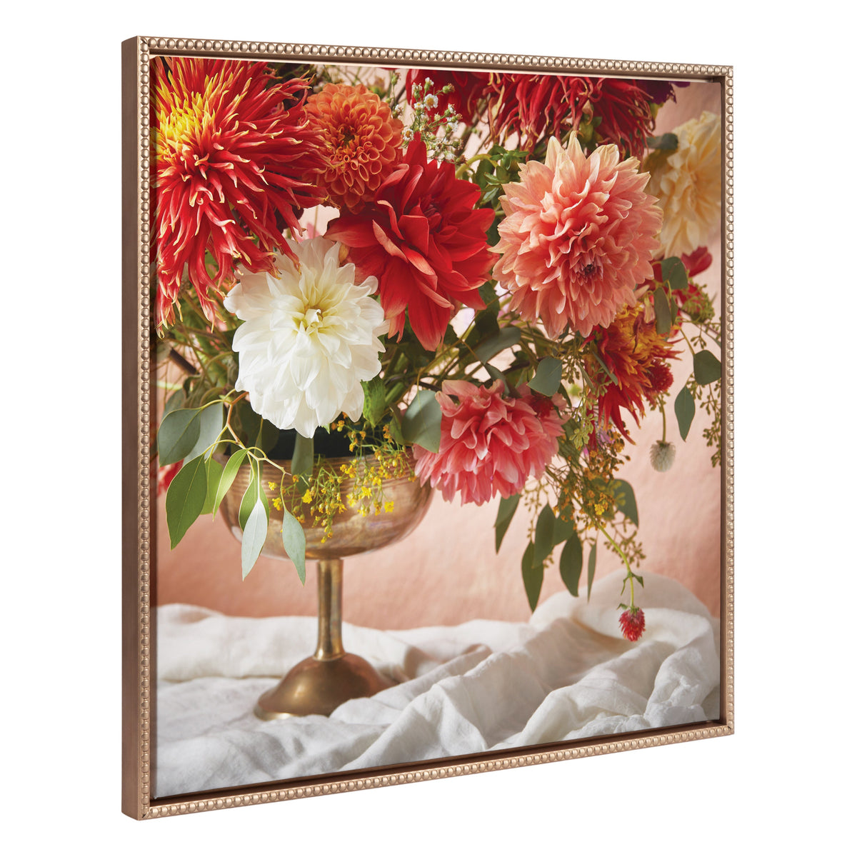 Framed canvas showing a lush floral arrangement with red, white, and pink dahlias in a bronze footed vase against a neutral background with draped white fabric.