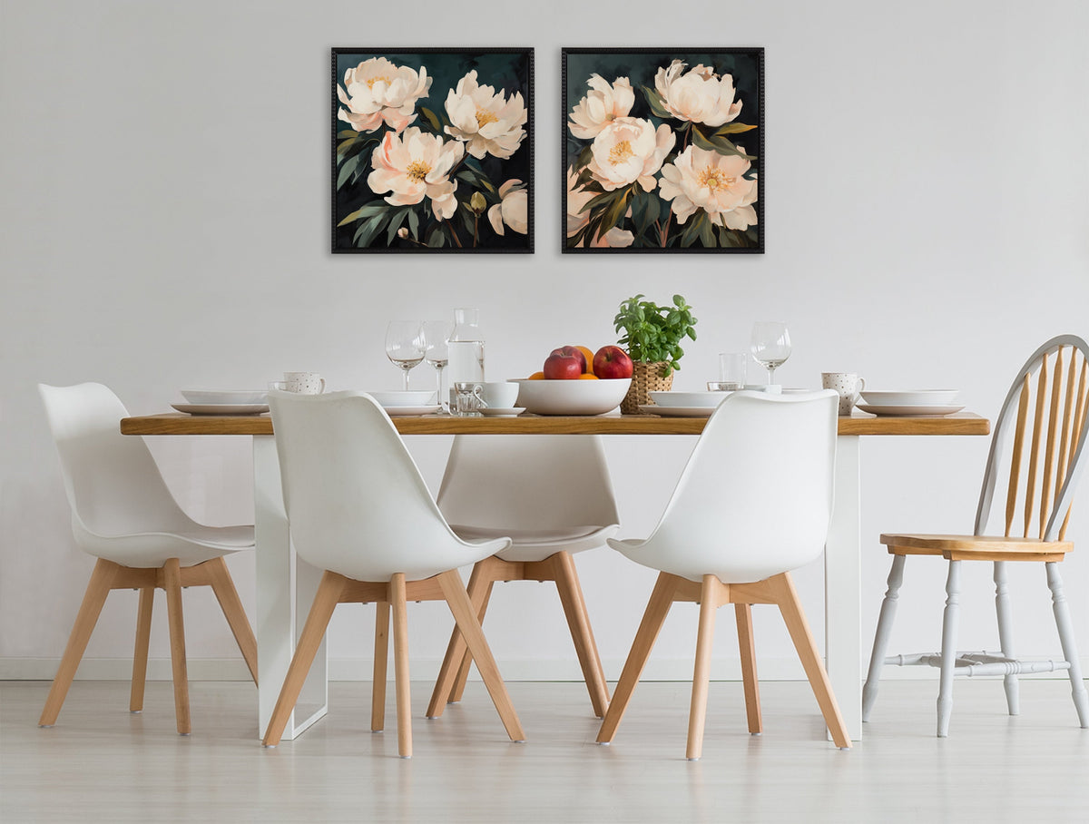 Dining area with a wooden-top white table surrounded by four white modern chairs and one wooden chair, beneath two framed floral canvas artworks with pale pink flowers on black backgrounds.