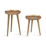 Set of two gold metal plant stands with scalloped round tops and tapered legs, one taller and one shorter, shown on white background.