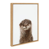 Framed canvas print featuring a close-up portrait of a brown otter with whiskers against a plain white background, encased in a light wood frame.