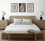 Minimalist bedroom with wooden bed frame and nightstands featuring black lamps, decorated with three framed neutral-toned line art canvases of abstract human figures.
