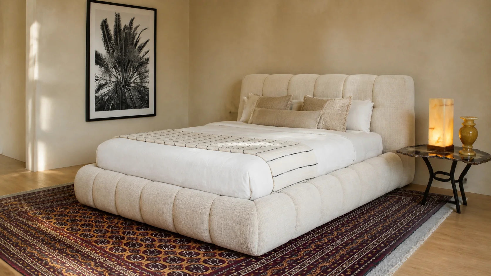 Bedroom styled with a designer bed, side tables, lamps and a hand-knotted rug