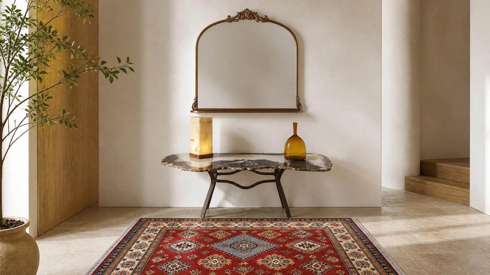 Grand entryway styled with a resin console, round mirror and sculptural vase